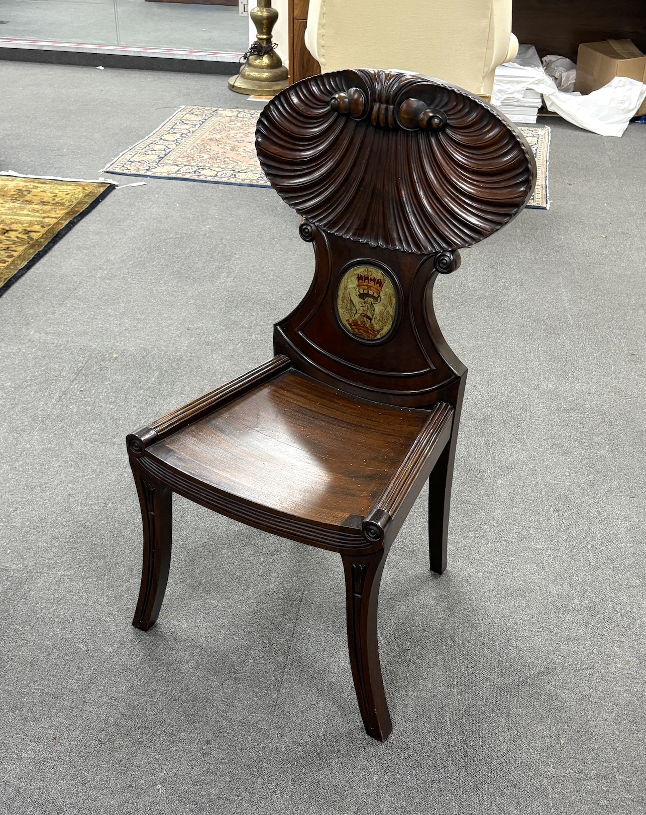 A George III style mahogany hall chair with painted armorial, width 39cm, depth 42cm, height 98cm